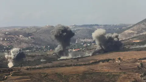 Reuters Smoke billows over the village of Aaichiyeh, in southern Lebanon, following Israeli strikes (20 October 2025)