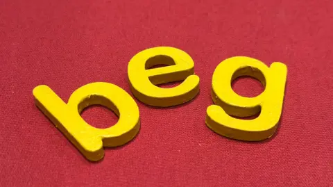 The word beg in yellow lettering on a red background.