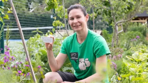 Freia Turland A woman holding a 3D printed token