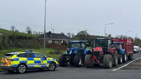 Claudia Savage/PA Protesters use tractors and trailers to block the Dublin Road roundabout in Co Cavan,where the N3, N55, and R212 all meet on the Cavan bypass, on the fourth day of a National Fuel Protest against rising fuel prices.