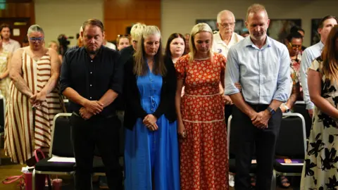 Jacob King/PA Wire left to right) Gary and Sarah Andrews, and Sarah and Jack Hawkins and the Nottingham families take part in a minute silence during a press conference at Crowne Plaza Hotel Nottingham, following the publication of former midwife Donna Ockenden's independent report into maternity care at Nottingham University Hospitals (NUH) NHS Trust, the largest maternity review in the history of the NHS, detailing how widespread failings led to the deaths of babies and caused avoidable harm. Picture date: Wednesday June 24, 2026. 