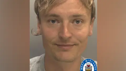 West Midlands Police A man with brown hair is looking at the camera. Part of the West Midlands Police logo is visible at the bottom of the image.