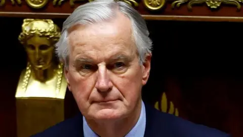 Michel Barnier with a grave expression