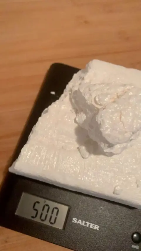 Nottinghamshire Police A large block of white powder is on top of weighing scales