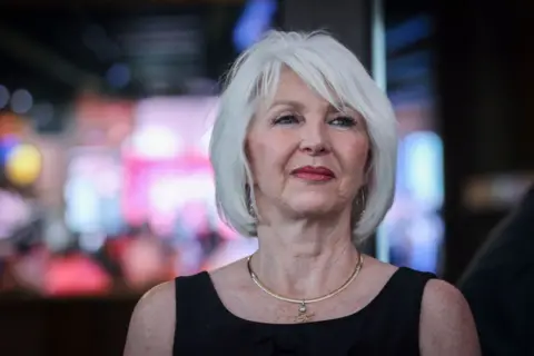 Getty Images Mesa County Clerk Tina Peters. She has a blonde bob and wears a gold necklace around her neck.