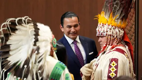 Reuters Headresses worn by First Nations people at Canada's opening of Parliament