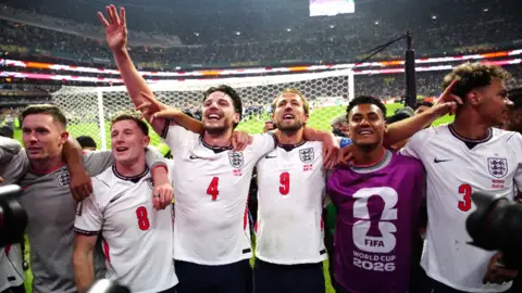 England players singing to the fans in the stands.