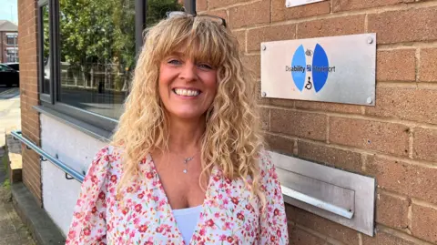 Sarah Crookdake, who helps run Disability Stockport, outside its office in the town centre