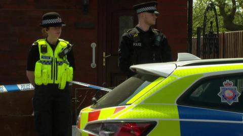 Police at the home of one of the men arrested over an alleged terror plot