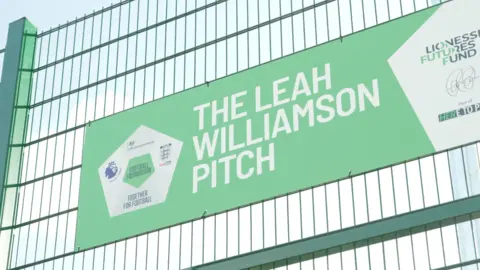 Ant Saddington/BBC Un cartel verde pegado a una barandilla verde, que dice: "El discurso de Leah Williamson."