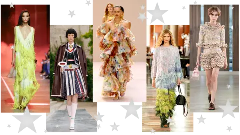 Five pictures of models walking down the catwalk. The first is in a fringed green dress with low v-neck; the second wears a striped pleated midi skirt, shirt and tie, tank top and blazer with brown leather coat draped over her shoulders; the third wears an off-shoulder, ruffled multicolour dress; the fourth wears a head-to-toe tasseled outfit with ombre blue and green effect; the fifth wears a ruffled mulitcolour mini skirt with ruffled three-quarter length sleeve top   