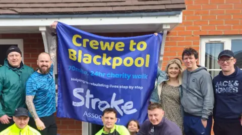 Matty Hassall The walkers with charity flag