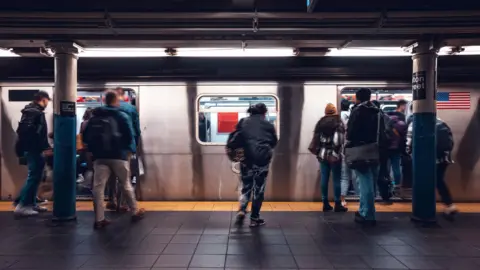 Getty Images A number of commuters pictured boarding the New York Subway 