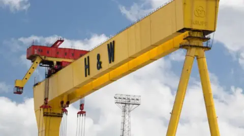 A Harland & Wolff crane against a blue sky