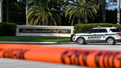 Getty Images A sheriff's deputy blocks a road outside Trump International Golf Club in West Palm Beach, Florida, on September 15, 2024, following a shooting at former U.S. President Donald Trump's golf course.