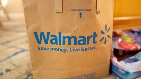 Getty Images Close-up of logo for Walmart on paper shopping bag, Newport Beach, California, December 24, 2025. (Photo by Smith Collection/Gado/Getty Images)
