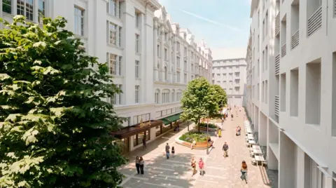Andy Sturgeon Design Image of a wide pedestrian street between white multi-storey buildings. Large trees and raised planted beds with wooden seating in the centre of the street. There are people walking along the paved walkway and some sitting. Shopfronts are visible on the left side of the street, with outdoor tables and chairs along the right side of the street