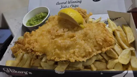 Fish and chips in a box, with mushy peas