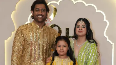 Reliance Former Indian cricket captain MS Dhoni with wife Sakshi and daughter