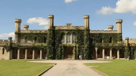 Exterior view of Lincoln Crown Court with ivy climbing up the crenelated walls.