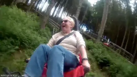 A woman looking excited on a woodland rollercoaster