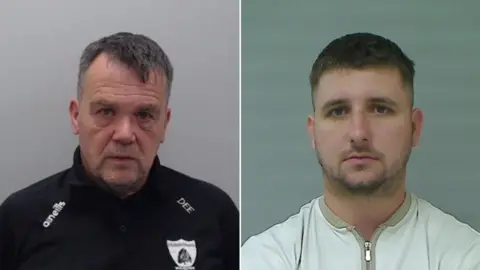 PSNI Damien Duffy has short dark hair that is greying and is wearing a black GAA training top. Shea Reynolds has short dark hair and stubble is wearing a light coloured zip up top 