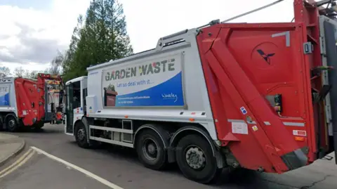 Waverley Borough Council bin lorry exiting a depot.