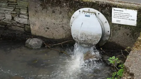 Getty Images A pipe releasing water in to Lake Windermere