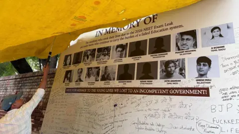Geeta Pandey/BBC A "memorial wall" has been built for students whose families have alleged that they killed themselves after the Neet exam was first cancelled