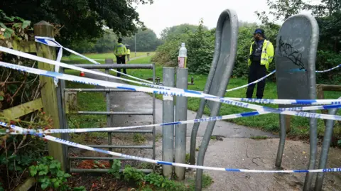 PA Media A police cordon in a park