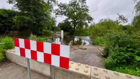 Martin Giles/BBC Concrete barriers at the ford