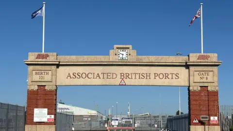 ABP Southampton Marathon Southampton's Dock Gate 8 a large stone arch over a road with flags on each side.