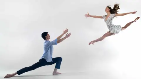 Len Copland A male and a female ballet dancer with the female doing the splits in the air