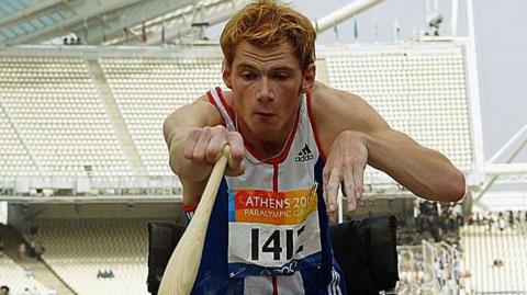 Stephen Miller throws the club during the Athens Paralympics