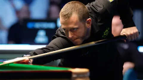 Mark Allen plays a shot 