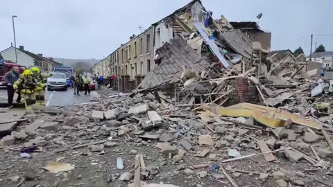 Alamgir Hossain Rubble in the street following house explosion