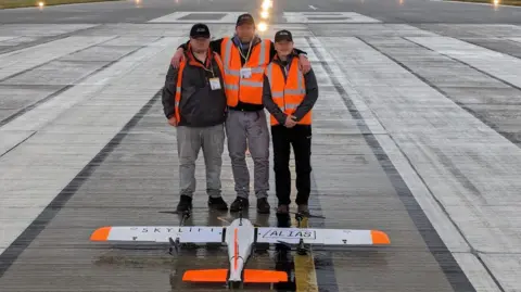 ALIAS consortium Three men and drone on runway