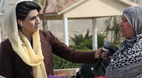 Reporter Shazia Haya is pictured interviewing another woman in Afghanistan