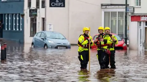 Recovery workers seen in flooded water