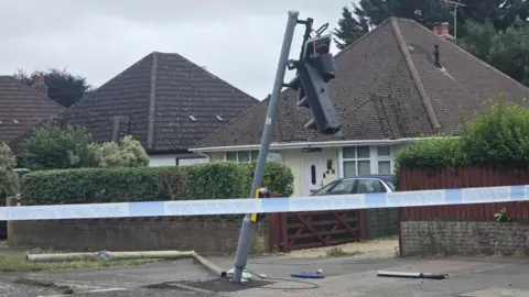 Damian Down A traffic light can be seen leaning on a tilt in the area of the crash