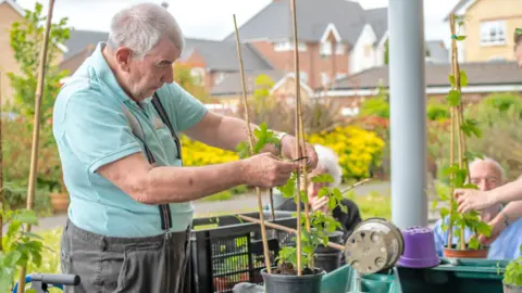 Guy Manchester A man gardening to help harvest the crops for the beer