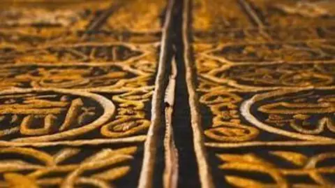 Kiswat-al-kaaba A close up of gold thread on black cloth