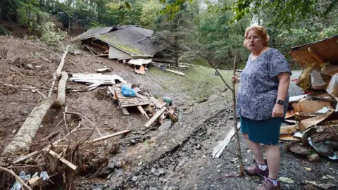 Reuters Meta Gatschenberger examines the remains of her collapsed and destroyed home in North Carolina