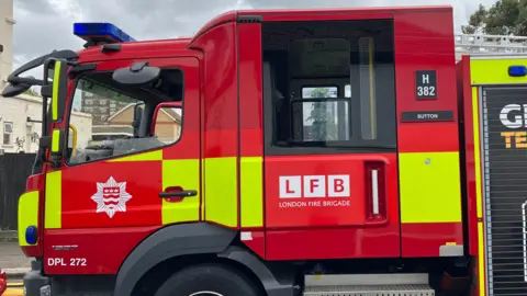 A red fire engine with the letters 'LFB'