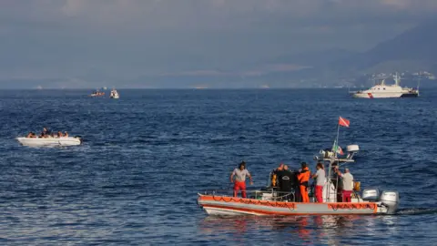 PA An Italian fire and rescue dive team on an inflatable boat on the water