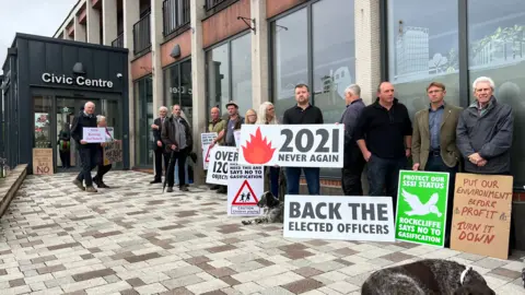Protestors gathered outside Carlisle Civic Centre, holding placards objecting to a proposed gasification plant near Rockcliffe, north Cumbria