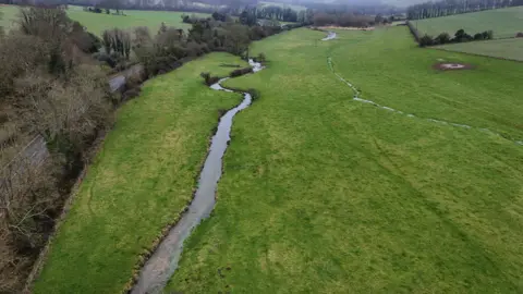 Chris Fairhead Aerial view of Court House area, which shows a stream running through a field.