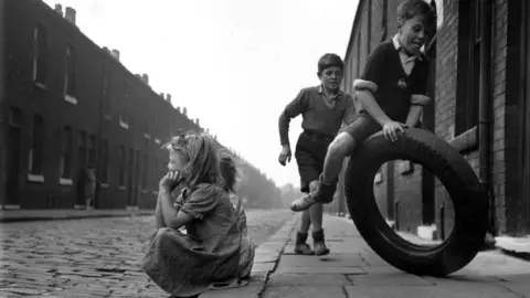 Getty Images Children playing in Salford in 1951