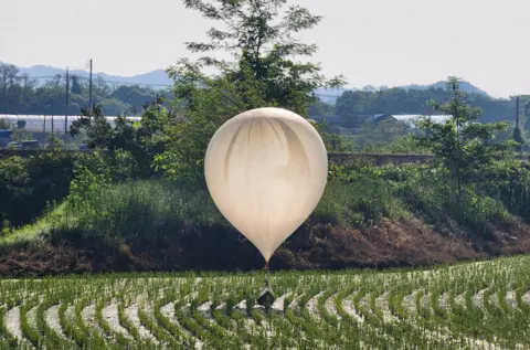 Reuters On 29 May, a balloon believed to have been sent by North Korea carrying various objects including what appeared to be trash and excrement was spotted over a rice field at Cheorwon, South Korea