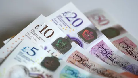 PA Media Stock image showing £5, £10, £20 and £50 banknotes.